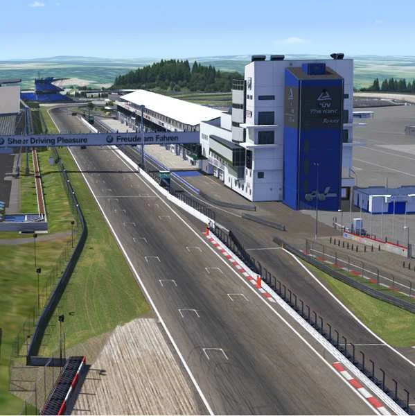 A sim racing circuit start-finish straight and pit buildings